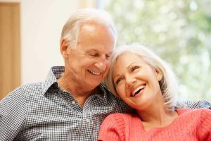 Older couple smiling and sitting close together